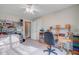 Well-lit bedroom with a desk, shelves, and a comfortable chair at 9447 Harroway Rd, Summerville, SC 29485