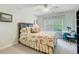 Bright bedroom with floral bedding, a window, and a small table set at 9447 Harroway Rd, Summerville, SC 29485