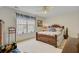 Comfortable bedroom with a wooden bed frame, ceiling fan, and natural light at 9447 Harroway Rd, Summerville, SC 29485