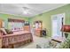 Comfortable bedroom with two twin beds, a large dresser, and natural light from the window at 9447 Harroway Rd, Summerville, SC 29485