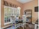 Charming breakfast nook with a round table, four chairs, and a large window overlooking the backyard at 9447 Harroway Rd, Summerville, SC 29485