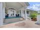 A clubhouse front porch with elegant white columns, seating, and double doors offers a welcoming entrance at 9447 Harroway Rd, Summerville, SC 29485