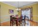 Bright dining room featuring classic decor, a wooden table, and a chandelier at 9447 Harroway Rd, Summerville, SC 29485