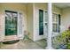 Cozy front porch featuring rocking chairs, a decorative statue, and charming architectural details at 9447 Harroway Rd, Summerville, SC 29485