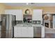 Updated kitchen with stainless steel appliances and a breakfast bar that opens to the living room at 9447 Harroway Rd, Summerville, SC 29485