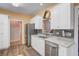 Well-appointed kitchen showcasing stainless steel appliances, granite counters, and updated backsplash at 9447 Harroway Rd, Summerville, SC 29485