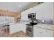 Stylish kitchen with white cabinets, stainless steel appliances, and a breakfast nook in the background at 9447 Harroway Rd, Summerville, SC 29485