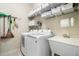 Well-organized laundry room with modern washer, dryer, and utility sink at 9447 Harroway Rd, Summerville, SC 29485