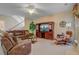 Cozy living room with brown leather furniture, a ceiling fan, and a large entertainment center at 9447 Harroway Rd, Summerville, SC 29485