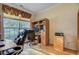 Functional home office with a large window, desk, shelving, and comfortable seating at 9447 Harroway Rd, Summerville, SC 29485