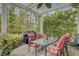 Covered patio with grill, dining table, and wooded views, perfect for outdoor entertaining at 9447 Harroway Rd, Summerville, SC 29485