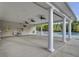 Open-air pool house with large support columns, ceiling fans, restroom access, and pool view at 9447 Harroway Rd, Summerville, SC 29485