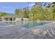 A community pool features a covered picnic area and is surrounded by mature trees under a blue sky at 9447 Harroway Rd, Summerville, SC 29485