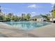 A community pool under a blue sky includes a covered picnic area, tables, and chairs at 9447 Harroway Rd, Summerville, SC 29485
