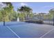 A community tennis court is adjacent to a pond with a fountain, all fenced in a private area at 9447 Harroway Rd, Summerville, SC 29485