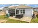 Backyard features a covered porch, hot tub, and lawn at 9703 Mosgrove Ave, Ladson, SC 29456