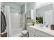 Bathroom with tub, shower, white vanity and mint green walls at 9703 Mosgrove Ave, Ladson, SC 29456