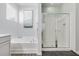 Bathroom with soaking tub, glass enclosed shower, vanity, and window with natural light at 9703 Mosgrove Ave, Ladson, SC 29456