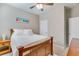 This bedroom features a wooden bedframe, plush white bedding, and a ceiling fan at 9703 Mosgrove Ave, Ladson, SC 29456