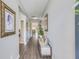 Long hallway with laminate flooring and decoratively framed art, leading to the living areas at 9703 Mosgrove Ave, Ladson, SC 29456