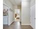 Hallway with wood floors leads to the laundry room and a bedroom with natural light at 9703 Mosgrove Ave, Ladson, SC 29456