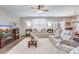 Cozy living room featuring modern furnishings, a ceiling fan, and large windows at 9703 Mosgrove Ave, Ladson, SC 29456
