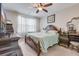 Beautiful main bedroom with wood furnishings, neutral walls and light-filled window at 9703 Mosgrove Ave, Ladson, SC 29456