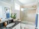 Bathroom featuring granite counters, a plant, vanity, and tiled shower/bath with a glass door at 975 Warrick Oaks Ln, Mount Pleasant, SC 29464
