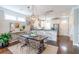 Open concept dining area with hardwood floors, a modern table, and stylish decor, flowing into the kitchen at 975 Warrick Oaks Ln, Mount Pleasant, SC 29464