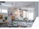Dining area showcasing stylish lighting, wood floors, and a view into the modern, open-concept kitchen at 975 Warrick Oaks Ln, Mount Pleasant, SC 29464