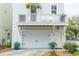 Three story home with garage, balcony, and lush landscaping at 975 Warrick Oaks Ln, Mount Pleasant, SC 29464