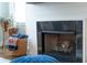 Close-up of a fireplace with a shiplap surround and a black granite hearth at 975 Warrick Oaks Ln, Mount Pleasant, SC 29464
