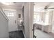 Bright foyer with tiled floor, staircase, front door, and adjacent office space with white desk at 975 Warrick Oaks Ln, Mount Pleasant, SC 29464