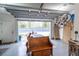 Well-lit garage with overhead storage, workbench, and an open garage door revealing the backyard at 975 Warrick Oaks Ln, Mount Pleasant, SC 29464