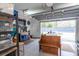 Spacious garage with workbench, storage shelving, and natural light, perfect for projects and organization at 975 Warrick Oaks Ln, Mount Pleasant, SC 29464