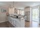 Bright kitchen with white cabinetry, granite countertops, stainless steel appliances, and a breakfast bar at 975 Warrick Oaks Ln, Mount Pleasant, SC 29464