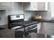 Close-up of a stainless steel stove and granite countertops in a modern kitchen at 975 Warrick Oaks Ln, Mount Pleasant, SC 29464