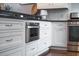 Elegant kitchen featuring stainless steel built-in oven, drawers, and white cabinets at 975 Warrick Oaks Ln, Mount Pleasant, SC 29464