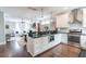 Open-concept kitchen featuring stainless steel appliances, a granite countertop island, and white cabinets at 975 Warrick Oaks Ln, Mount Pleasant, SC 29464