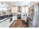 Modern kitchen with white cabinets, stainless steel appliances, granite countertops, and hardwood floors at 975 Warrick Oaks Ln, Mount Pleasant, SC 29464