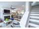 Open-concept living room with fireplace, hardwood floors, and a view into the kitchen and dining area at 975 Warrick Oaks Ln, Mount Pleasant, SC 29464