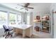 Bright office with white walls, large windows, ceiling fan, and a custom white desk and hutch at 975 Warrick Oaks Ln, Mount Pleasant, SC 29464