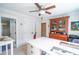 Bright office featuring white walls, windows, ceiling fan, an antique hutch and a sewing area at 975 Warrick Oaks Ln, Mount Pleasant, SC 29464
