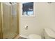 Updated shower with glass doors, modern fixtures and vanity, with a light-filled window at 1 Battery Park Rd, Edisto Island, SC 29438
