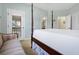 Tranquil bedroom featuring a four-poster bed, ensuite bath and access to private porch at 1 Battery Park Rd, Edisto Island, SC 29438