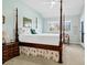 Bright bedroom featuring a four-poster bed, sitting area and access to private porch at 1 Battery Park Rd, Edisto Island, SC 29438