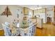 Cozy dining area with a glass table, decorative chairs, and an open kitchen area at 1 Battery Park Rd, Edisto Island, SC 29438