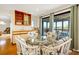 Bright dining area with glass table, decorative chairs, wet bar and view of the water at 1 Battery Park Rd, Edisto Island, SC 29438