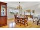 Elegant dining room with wood floors, a large table, a china cabinet, and a decorative chandelier at 1 Battery Park Rd, Edisto Island, SC 29438
