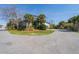 Lovely two-story home featuring well-manicured lawns, lush greenery, and mature palm trees at 1 Battery Park Rd, Edisto Island, SC 29438